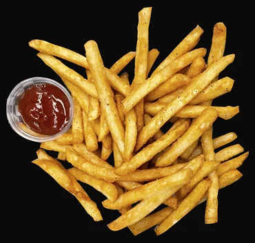 Golden French fries with a cup of ketchup