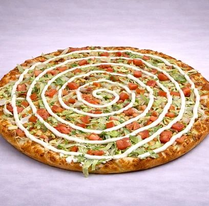 Donair pizza with lettuce, tomato and a spiral of sweet sauce