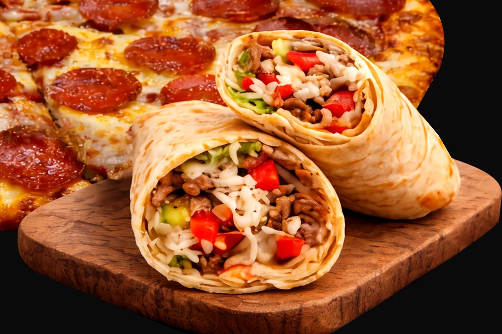 Beef donair cut in half, wrapped in pita with tomato, lettuce and cheese, on a wooden board